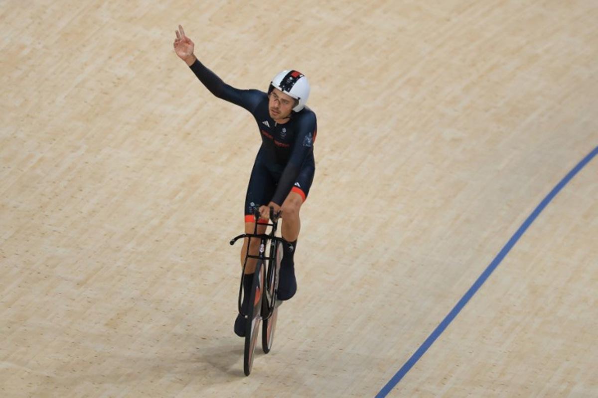 Britain's Charlie Tanfield reacts after a men's track cycling team pursuit first round of the Paris 2024 Olympic Games at the Saint-Quentin-en-Yvelines National Velodrome in Montigny-le-Bretonneux, south-west of Paris, on August 6, 2024.  Emmanuel DUNAND / AFP