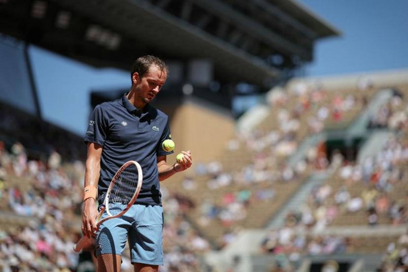 Daniil Medvedev selects a ball as he prepares to serve to Australia's Adam Walton during their men's singles match on day 3 of the French Open tennis tournament on Court Suzanne-Lenglen at the Roland-Garros Complex in Paris on May 26, 2026.  Thomas SAMSON / AFP