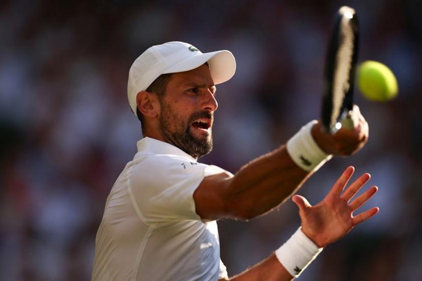 Serbia's Novak Djokovic plays a forehand return to Italy's Jannik Sinner during their men's singles semi-final tennis match on the twelfth day of the 2025 Wimbledon Championships at The All England Lawn Tennis and Croquet Club in Wimbledon, southwest London, on July 11, 2025.  HENRY NICHOLLS / AFP