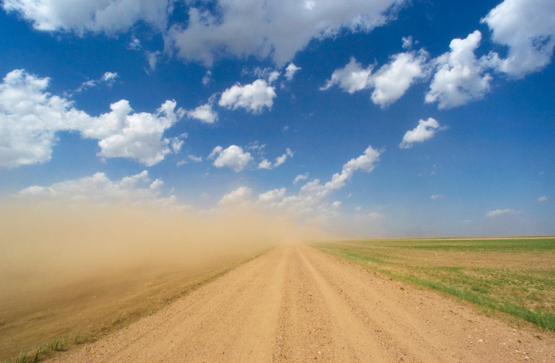 Dust storm. Wind-swept cloud of dust approaching a road in western Kansas, USA.