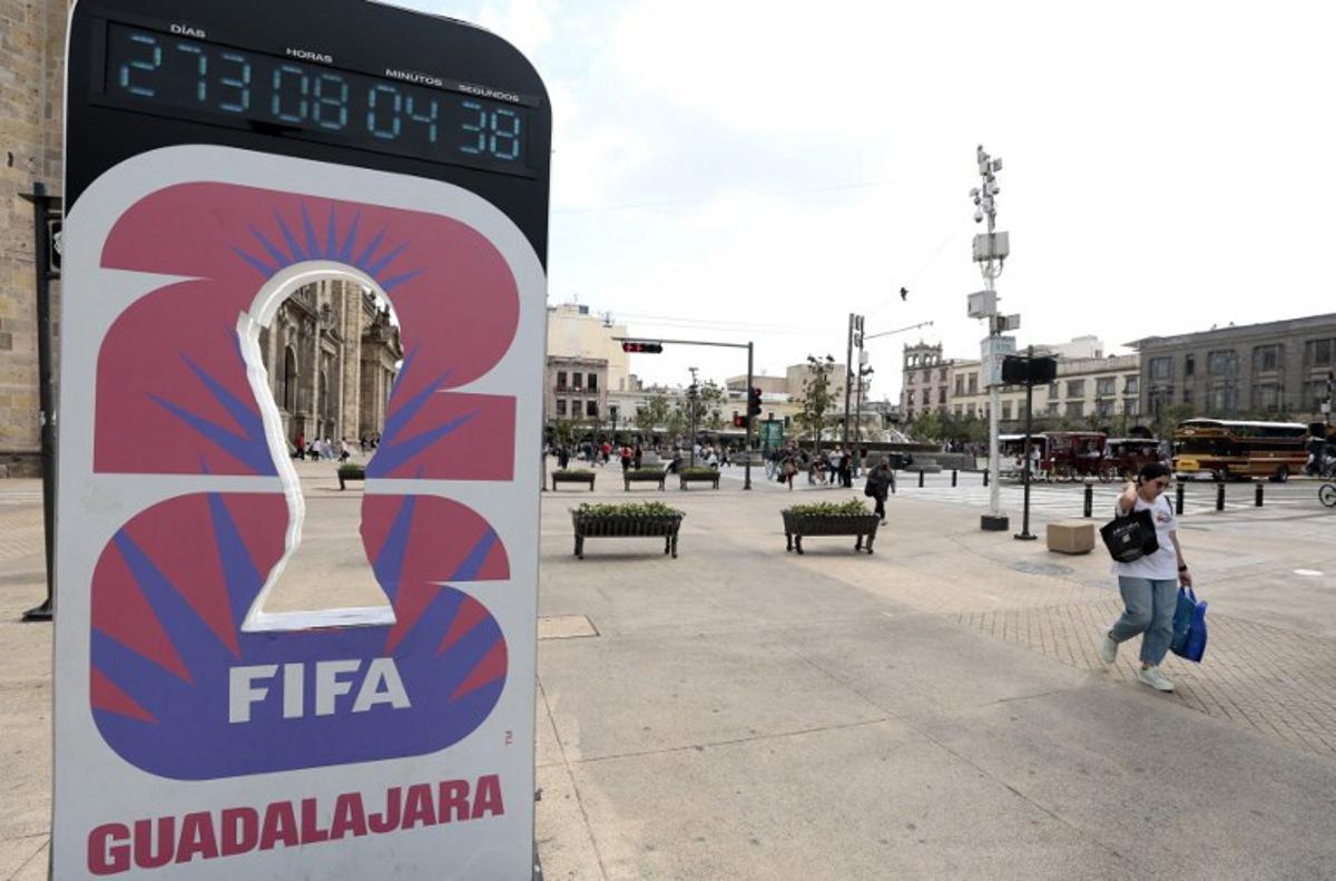 A woman walks past the FIFA World Cup 2026 countdown clock in Guadalajara, Jalisco state, Mexico on September 10, 2025. Registration is now open to participate in the ticket lottery for the 2026 FIFA World Cup, which will be held in Mexico, the United States, and Canada, with the opening match taking place at the Azteca Stadium in Mexico City on June 11, 2026. ULISES RUIZ / AFP