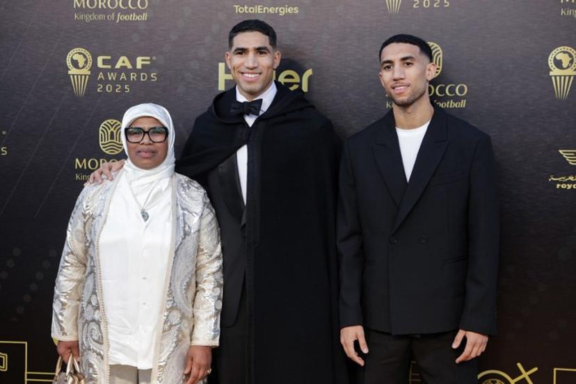 Paris Saint-Germain's Moroccan defender Achraf Hakimi (C) poses for a picture with members of his family as he arrives for the 2025 Confederation of African Football (CAF) Awards in Sale, Morocco on November 19, 2025.  Abdel Majid BZIOUAT / AFP