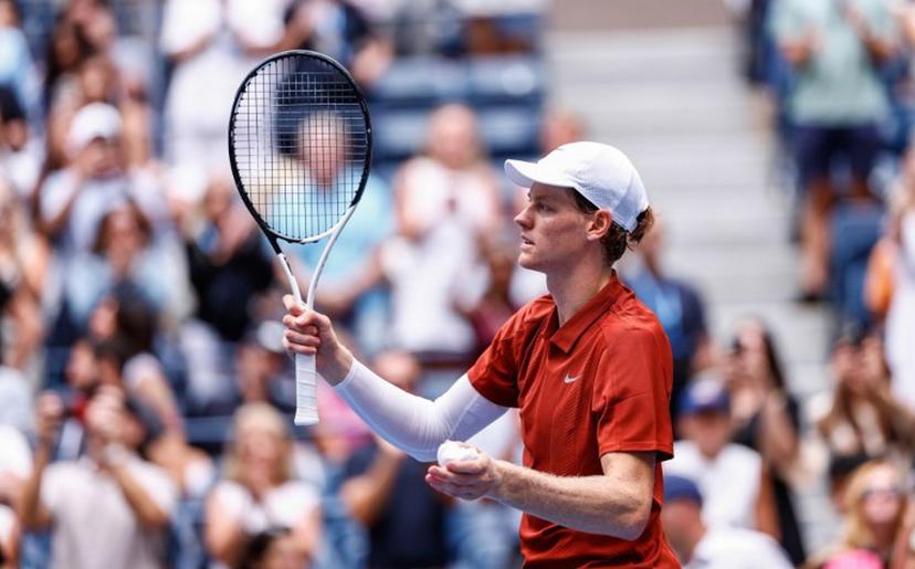 Italy's Jannik Sinner (L) celebrates defeating Australia's Alexei Popyrin in their men's singles second round match against on day five of the US Open tennis tournament at the USTA Billie Jean King National Tennis Center in New York City on August 28, 2025.  Kena Betancur / AFP