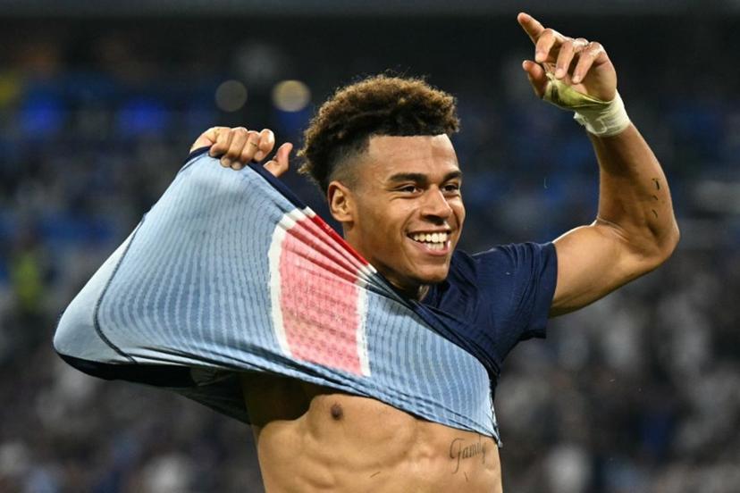 Paris Saint-Germain's French midfielder #14 Desire Doue removes his shirt as he celebrates after scoring PSG's third goal during the UEFA Champions League final football match between Paris Saint-Germain (PSG) and Inter Milan in Munich, southern Germany, on May 31, 2025.  INA FASSBENDER / AFP