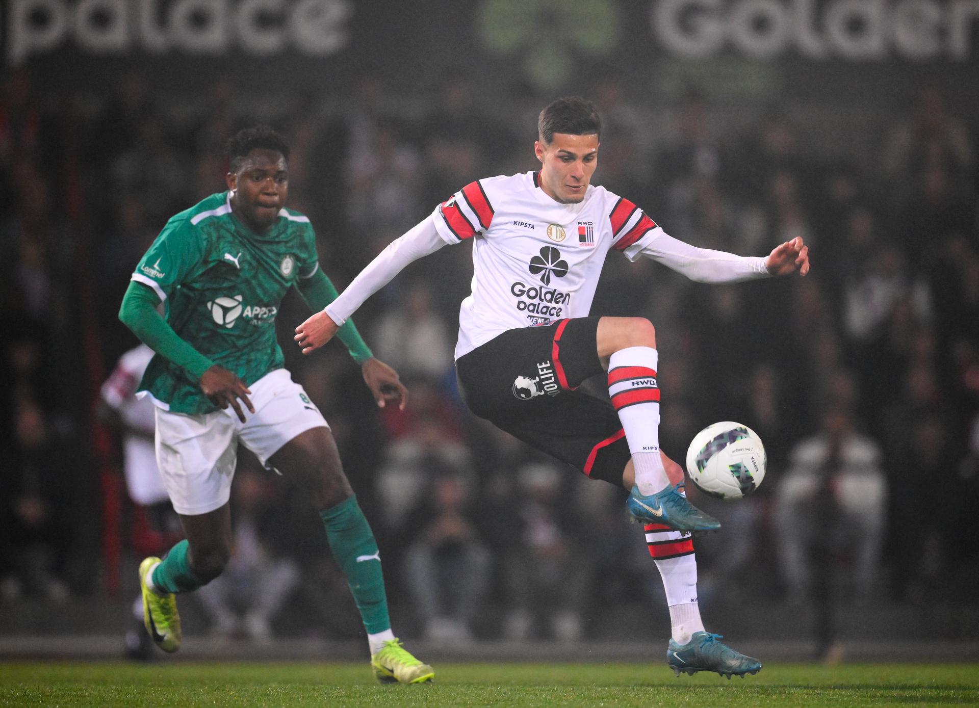 Lommel's Ibrahima Kebe and Rwdm's Romildo Del Piage fight for the ball during a soccer match between RWD Molenbeek and Lommel SK, Friday 11 April 2025 in Brussels, on day 29 of the 2024-2025 'Challenger Pro League' 1B second division of the Belgian championship. BELGA PHOTO JOHN THYS