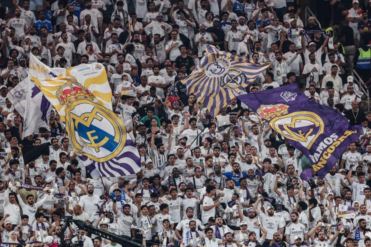 Real Madrid's fans cheer for their team during the Spanish Super Cup final football match between FC Barcelona and Real Madrid at the King Abdullah Stadium in Jeddah on January 11, 2026.  Haitham AL-SHUKAIRI / AFP