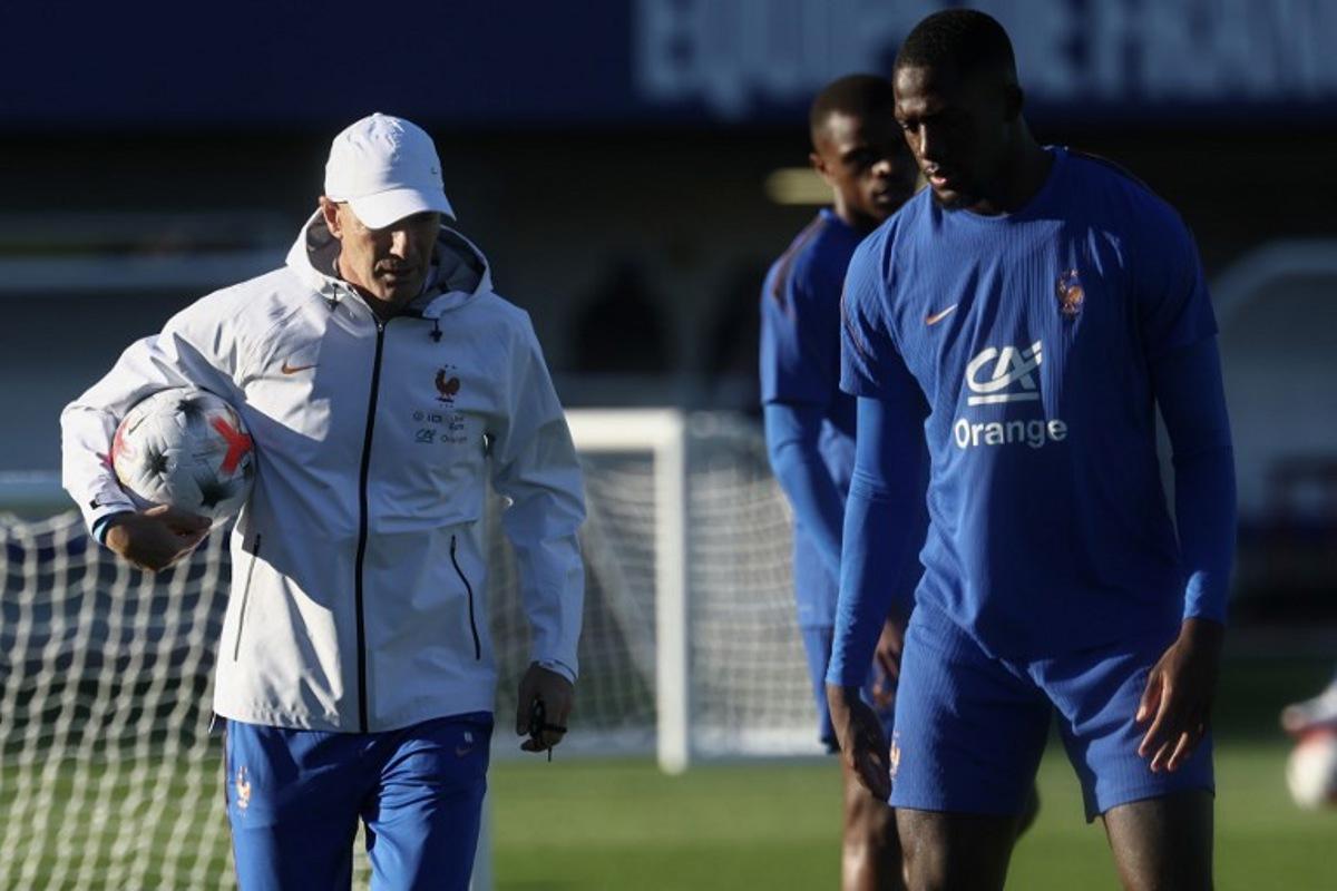 France's head coach Zinedine Zidane (L) and France's defender Ibrahima Konate attends a training session at the national team training grounds in Clairefontaine-en-Yvelines, southwest of Paris, on September 22, 2026, as part of the preparation for the upcoming UEFA Nations League football match against Turkey.   FRANCK FIFE / AFP