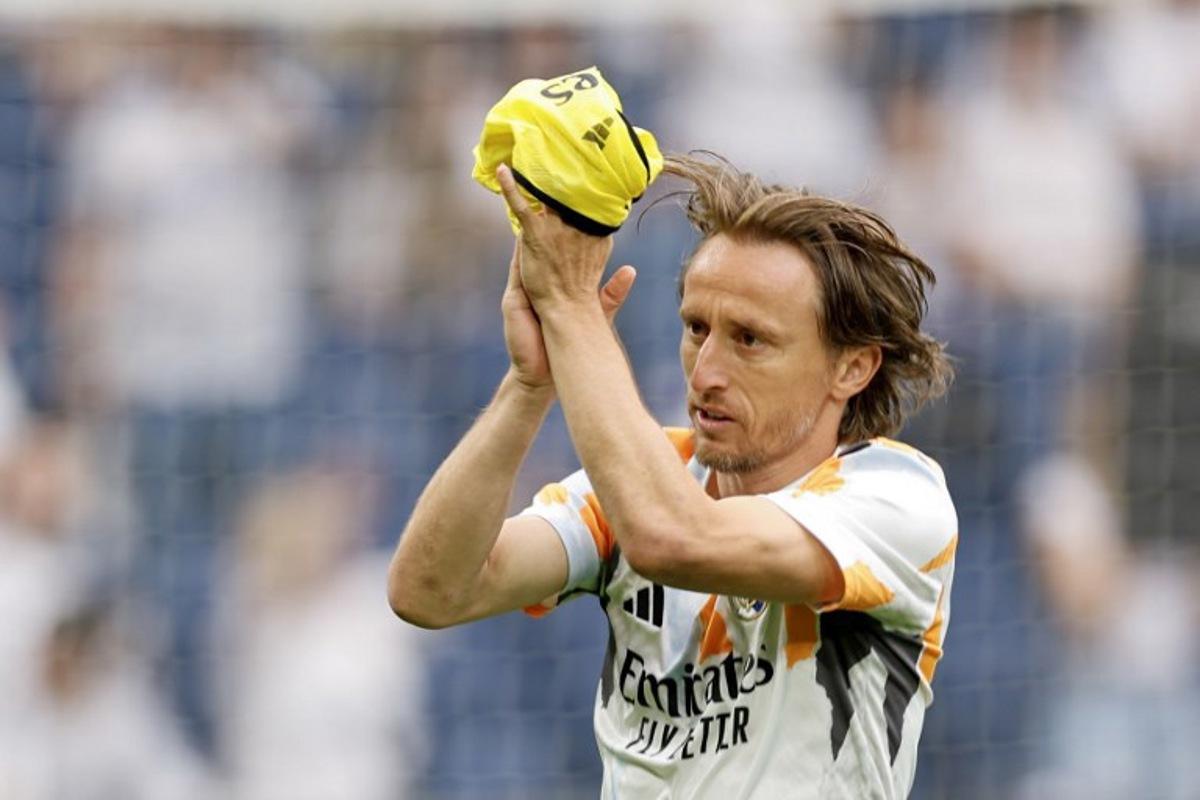 Real Madrid's Croatian midfielder #10 Luka Modric acknowledges supporters before the Spanish league football match between Real Madrid CF and Real Sociedad at Santiago Bernabeu Stadium in Madrid on May 24, 2025.  OSCAR DEL POZO / AFP
