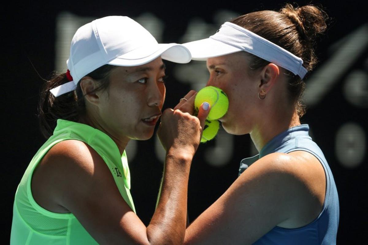 China's Zhang Shuai (L) talks to partner Belgium's Elise Mertens during their women's doubles final match against Kazakhstan's Anna Danilina and Serbia's Aleksandra Krunic on day fourteen of the Australian Open tennis tournament in Melbourne on January 31, 2026.  DAVID GRAY / AFP