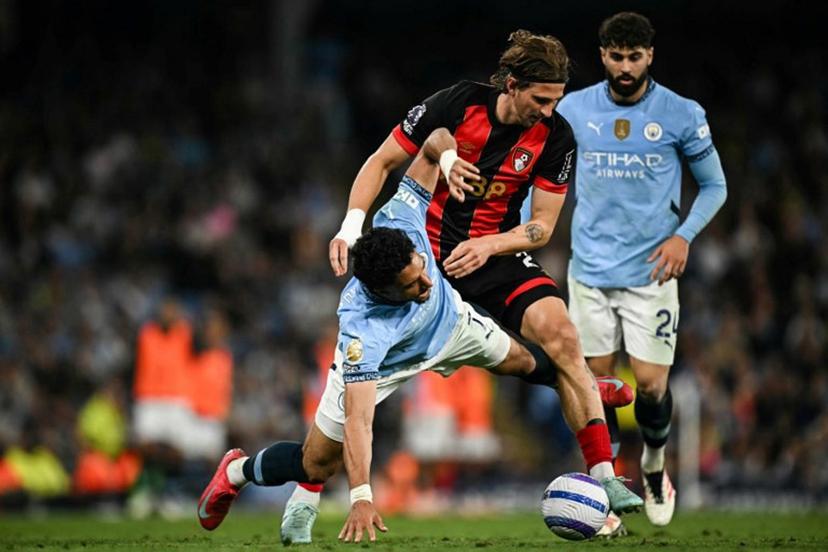 Manchester City's Egyptian striker #07 Omar Marmoush (L) fights for the ball with Bournemouth's Ukrainian defender #27 Illia Zabarnyi (C) during the English Premier League football match between Manchester City and Bournemouth at the Etihad Stadium in Manchester, north west England, on May 20, 2025.  Paul ELLIS / AFP