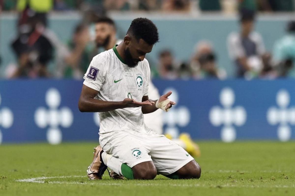 Saudi Arabia's forward #09 Firas Al-Buraikan kneels at the end of the Qatar 2022 World Cup Group C football match between Saudi Arabia and Mexico at the Lusail Stadium in Lusail, north of Doha on November 30, 2022.  Khaled DESOUKI / AFP
