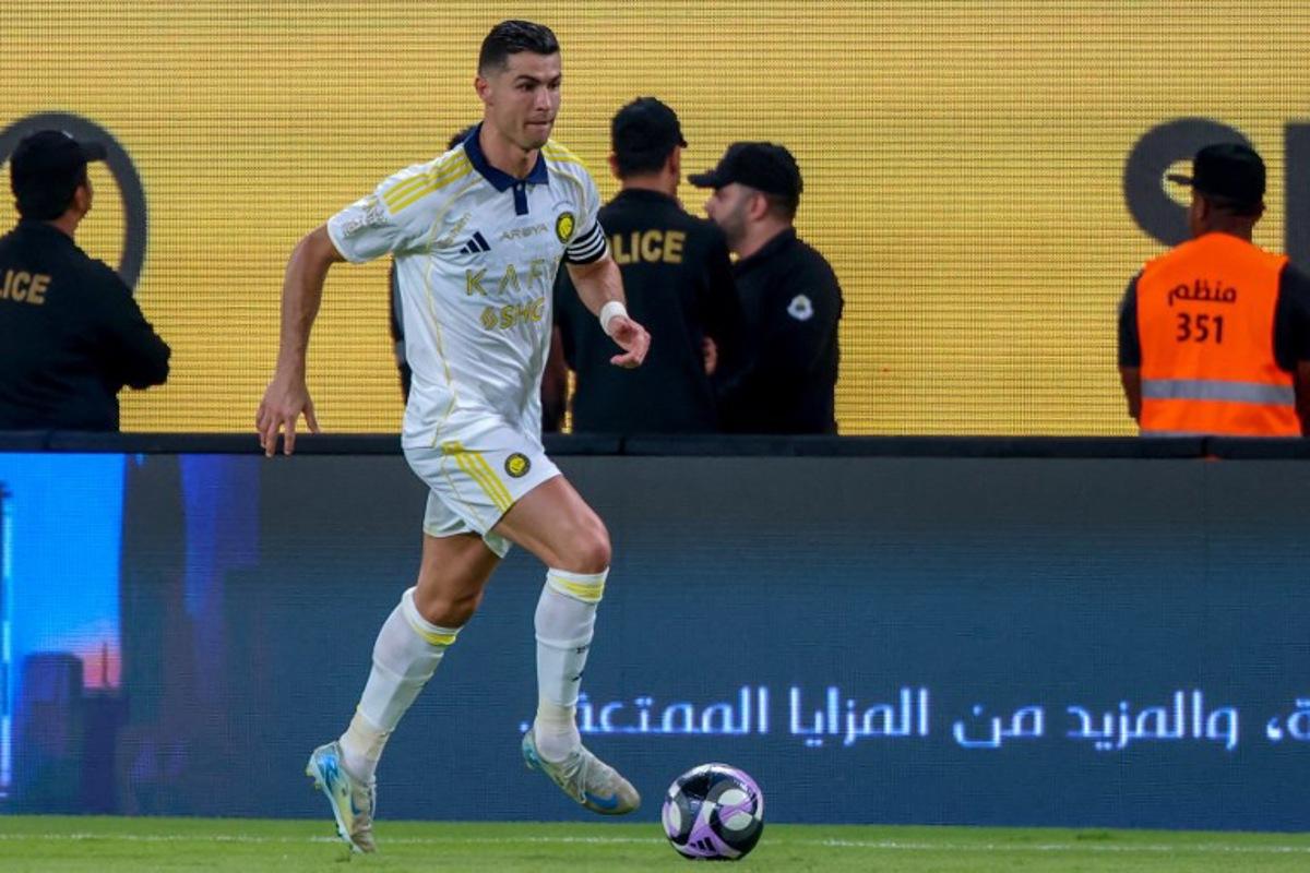Nassr's Portuguese forward #7 Cristiano Ronaldo runs with the ball during the Saudi Pro League football match between Al-Nassr and Al-Khaleej at Al-Awwal Park in Riyadh on May 21, 2025.  Fayez NURELDINE / AFP