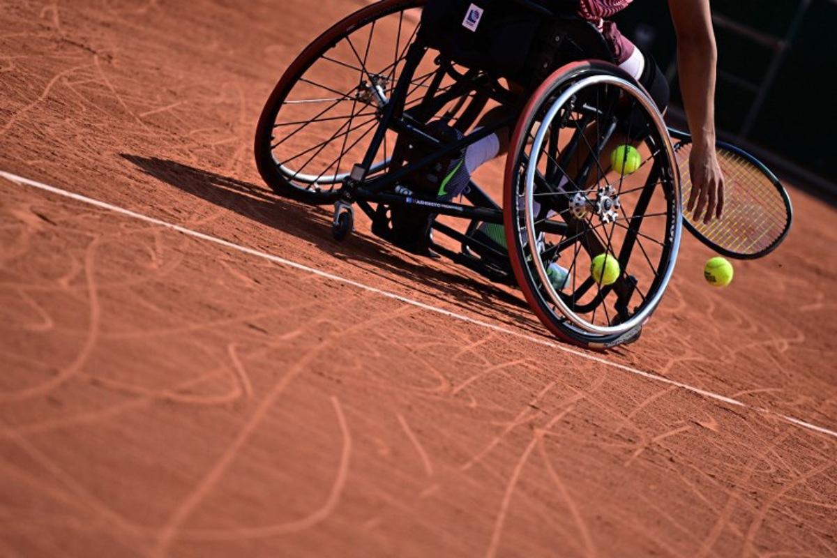Tennis balls are seen in the wheel of a player's wheelchair during a men's wheelchair singles match on day ten of the Roland-Garros Open tennis tournament in Paris on June 6, 2023.  JULIEN DE ROSA / AFP