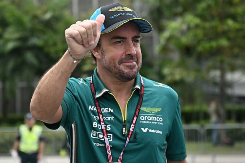 Aston Martin's Spanish driver Fernando Alonso gestures to fans before the first practice session ahead of the Formula One Singapore Grand Prix night race at the Marina Bay Street Circuit in Singapore on October 3, 2025.  Lillian SUWANRUMPHA / AFP