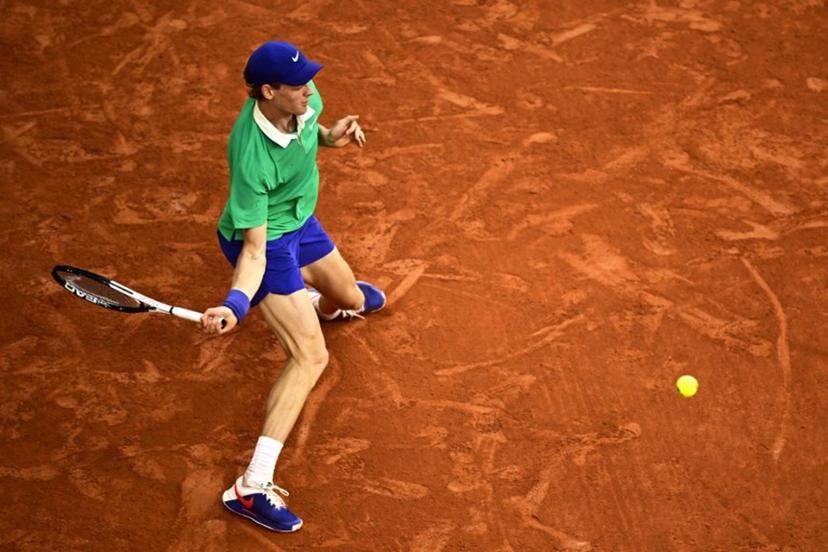 Italy's Jannik Sinner plays a forehand return to Serbia's Novak Djokovic during their men's singles semi-final match on day 13 of the French Open tennis tournament on Court Philippe-Chatrier at the Roland-Garros Complex in Paris on June 6, 2025.  JULIEN DE ROSA / AFP