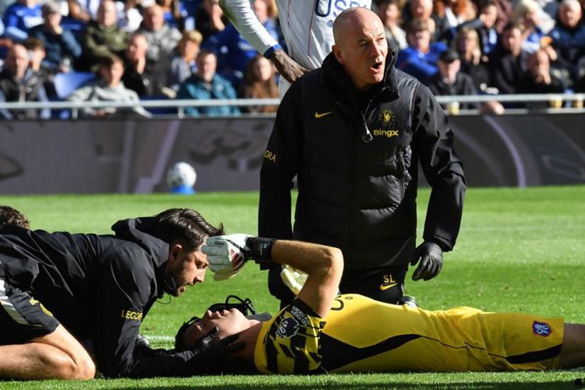Chelsea's Argentinian goalkeeper #26 Emiliano Martinez is treated after picking up an injury during the English Premier League football match between Everton and Chelsea at Hill Dickinson Stadium in Liverpool, north west England on October 17, 2026.  PETER POWELL / AFP