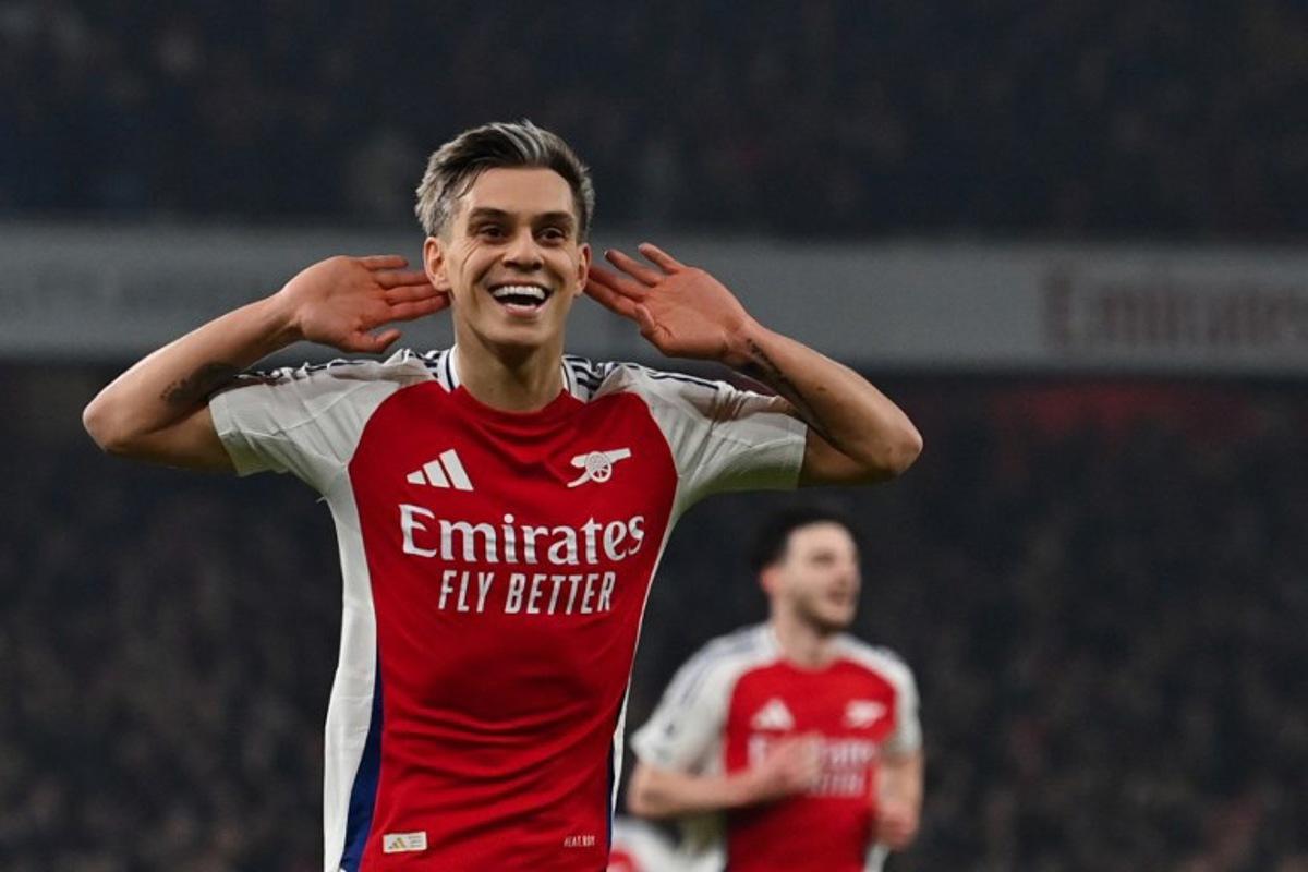 Arsenal's Belgian midfielder #19 Leandro Trossard celebrates after scoring his team second goal during the English Premier League football match between Arsenal and Tottenham Hotspur at the Emirates Stadium in London on January 15, 2025.   Glyn KIRK / AFP