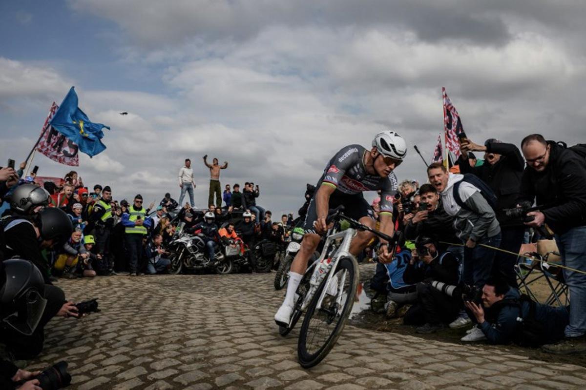 Alpecin-Deceuninck's Dutch rider Mathieu van der Poel cycles in a breakaway leading the race at the Carrefour de l'Arbre, a cobblestone road, during the 122nd edition of the Paris-Roubaix one-day classic cycling race, 259,2 km between Compiegne and Roubaix, northern France on April 13, 2025.  JEFF PACHOUD / AFP