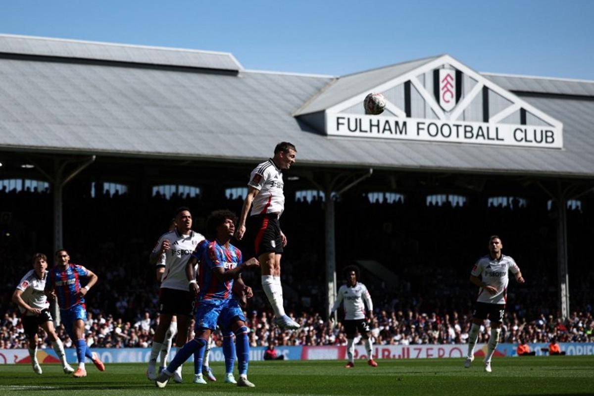 Fulham's Belgian defender #21 Timothy Castagne (C) heads the ball clear during the English FA Cup quarter-final football match between Fulham and Crystal Palace at Craven Cottage in Fulham, west London on March 29, 2025.  HENRY NICHOLLS / AFP