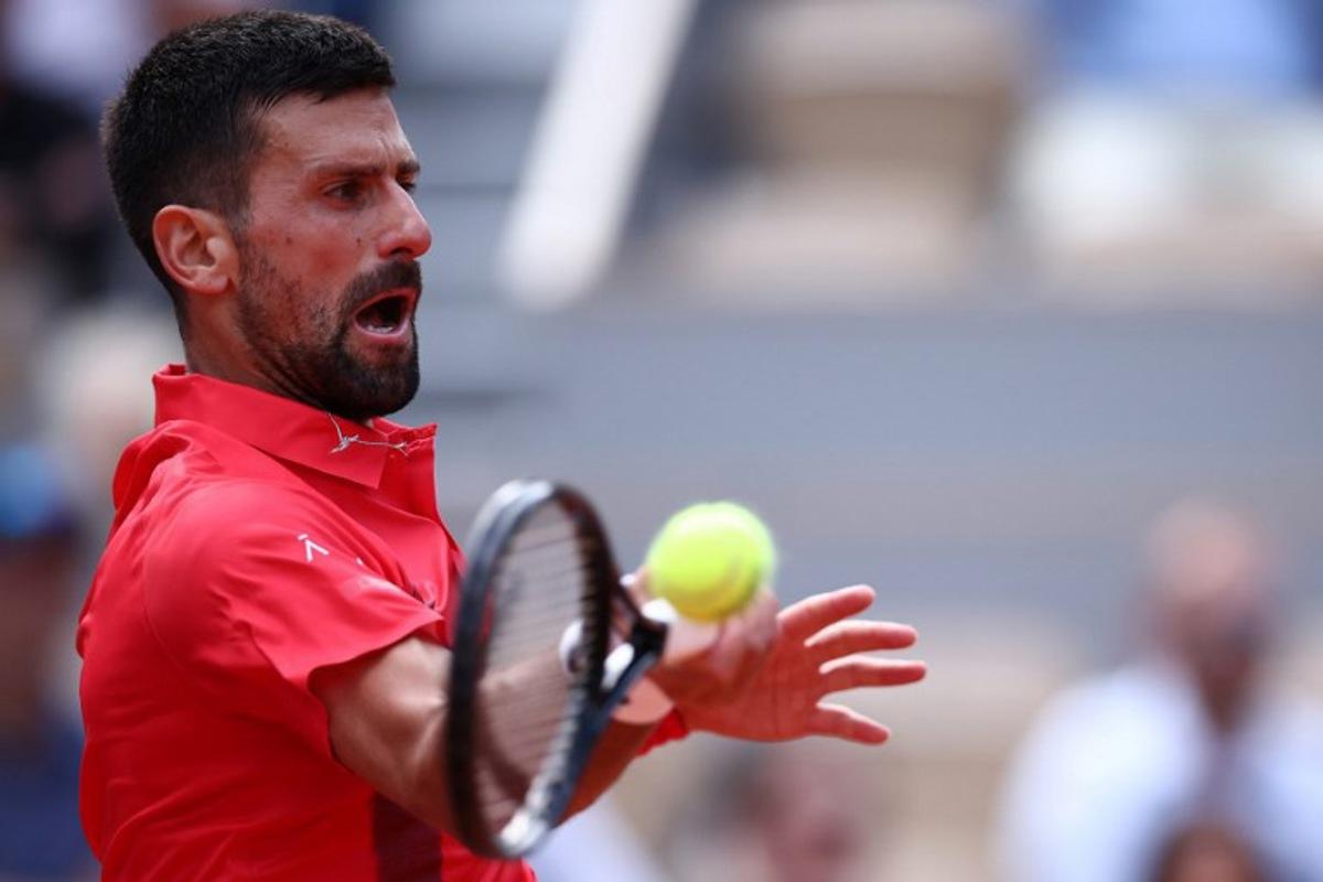 Serbia's Novak Djokovic plays a forehand return to Britain's Cameron Norrie during their men's singles match on day 9 of the French Open tennis tournament on Court Philippe-Chatrier at the Roland-Garros Complex in Paris on June 2, 2025.  Anne-Christine POUJOULAT / AFP
