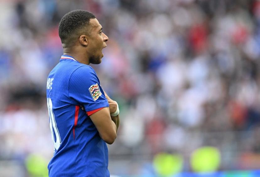 France's forward #10 Kylian Mbappe celebrates scoring the opening goal during the UEFA Nations League third place play-off football match between Germany and France in Stuttgart, southwestern Germany on June 8, 2025.  THOMAS KIENZLE / AFP