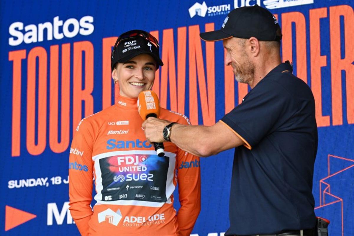FDJ United-Suez rider Ally Wollaston (L) of New Zealand speaks during a post race interview after winning the second stage of the women's 2026 Tour Down Under cycling race in Adelaide on January 18, 2026.  Michael ERREY / AFP