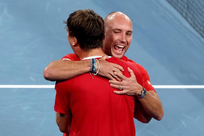 Belgium's Raphael Collignon (L) celebrates with team captain Steve Darcis after defeating Australia's Alek Vukic during the Davis Cup second-round qualifier tennis match at Ken Rosewall Arena in Sydney on September 14, 2025.  DAVID GRAY / AFP