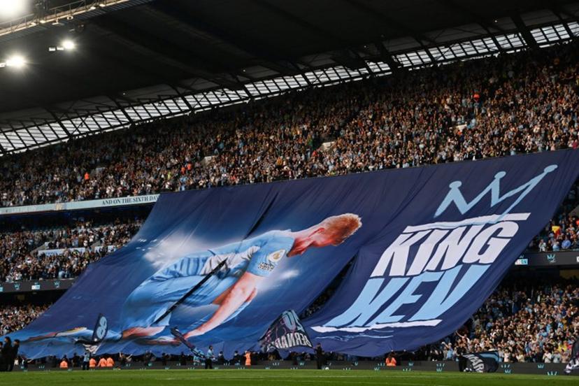 Manchester City supporters wave a banner picturing Manchester City's Belgian midfielder #17 Kevin De Bruyne to celebrate the player last match ahead of vthe English Premier League football match between Manchester City and Bournemouth at the Etihad Stadium in Manchester, north west England, on May 20, 2025.  Paul ELLIS / AFP