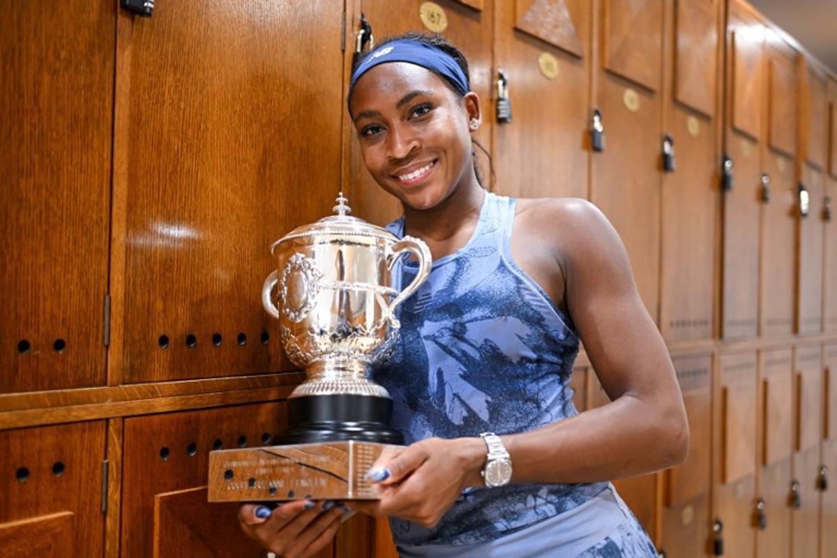 In this handout photograph taken and released on June 7, 2025 by French Tennis Federation (FFT) US Coco Gauff poses with her trophy at the locker room, after winning the women's singles final match against Belarus' Aryna Sabalenka on day 14 of the French Open tennis tournament at the Roland-Garros Complex in Paris.  Corinne DUBREUIL / French Tennis Federation -FFT / AFP