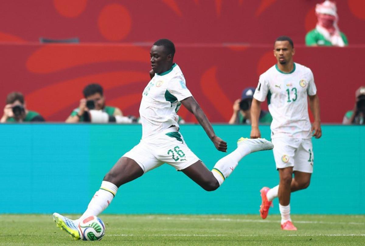 Senegal's midfielder #26 Pape Gueye scores his team's third goal during the 2026 World Cup Group I football match between Senegal and Iraq at the Toronto Stadium in Toronto on June 26, 2026.   Cole Burston / AFP