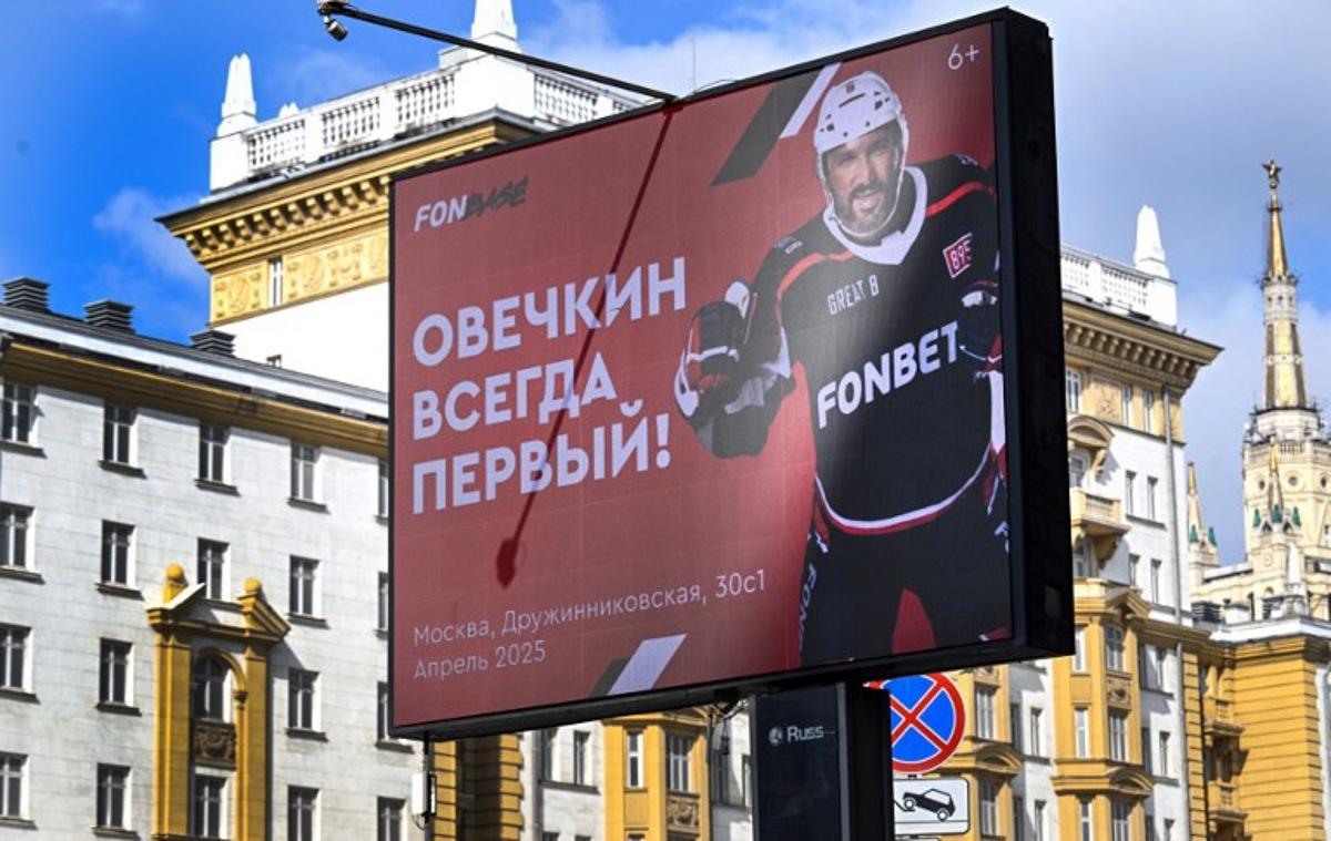An advertising screen displaying an image of Russian ice hockey star Alexander Ovechkin, reading "Ovechkin is Always the First!" seen in Moscow next to the US embassy on April 2, 2025. Washington Capitals star Alex Ovechkin scored his 891st goal for the Washington Capitals against the Boston Bruins at TD Garden on April 1, to move within four of breaking Wayne Gretzky's NHL record of 894 goals. Alexander NEMENOV / AFP