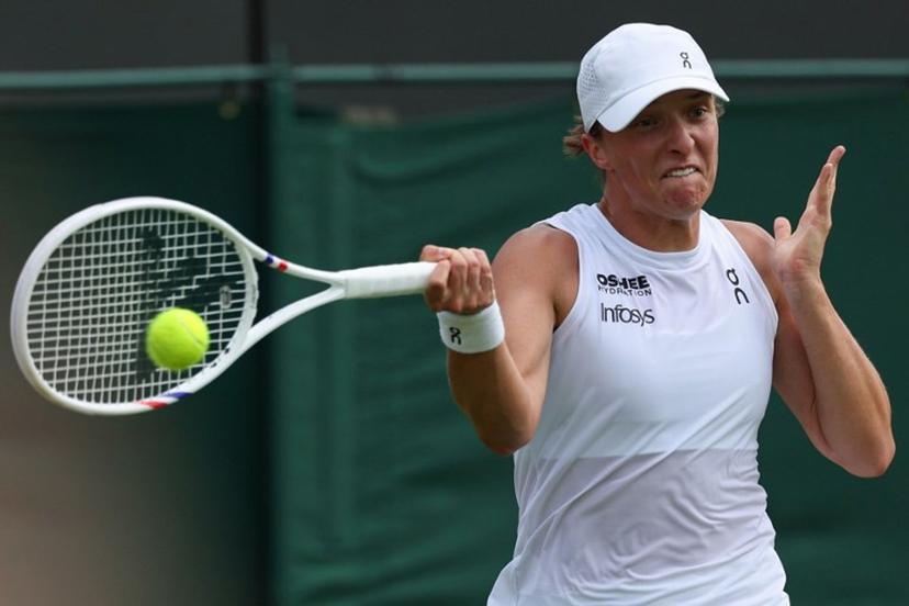 Poland's Iga Swiatek plays a forehand return to Russia's Polina Kudermetova during their women's singles first round tennis match on the second day of the 2025 Wimbledon Championships at The All England Lawn Tennis and Croquet Club in Wimbledon, southwest London, on July 1, 2025.  Adrian Dennis / AFP