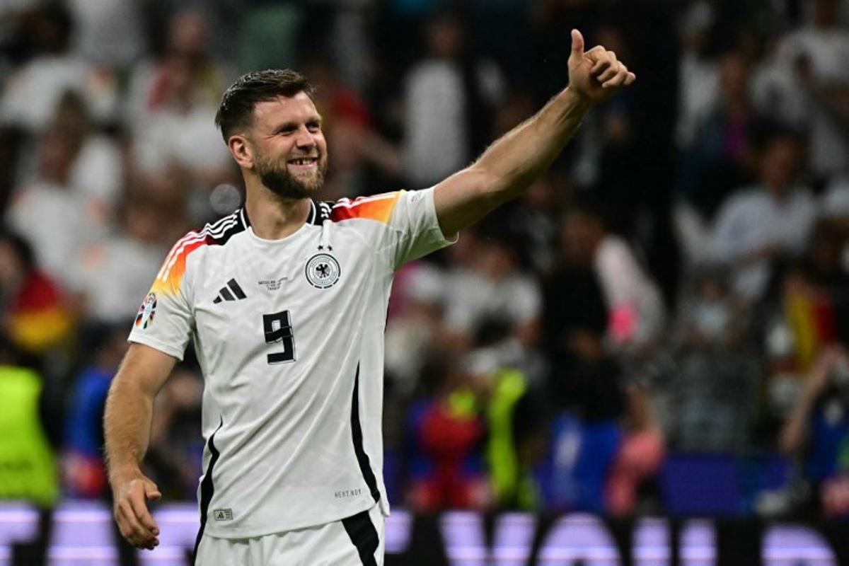 Germany's forward #09 Niclas Fullkrug celebrates after the UEFA Euro 2024 Group A football match between Switzerland and Germany at the Frankfurt Arena in Frankfurt am Main on June 23, 2024.  Tobias SCHWARZ / AFP