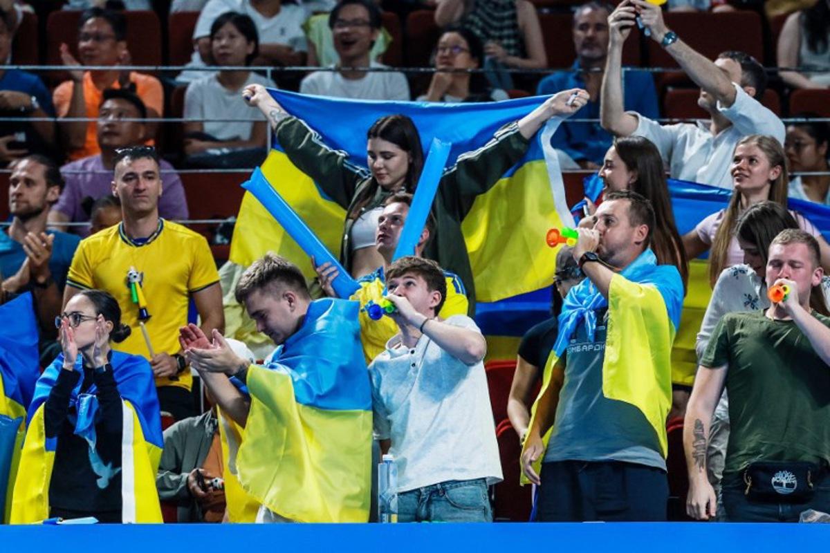 Ukraine's supporters cheer on Anhelina Kalinina during her women's singles semi-final match against Italy's Tyra Grant at the Billie Jean King Cup tennis tournament in Shenzhen, in China's southern Guangdong province on September 26, 2026.   CN-STR / AFP