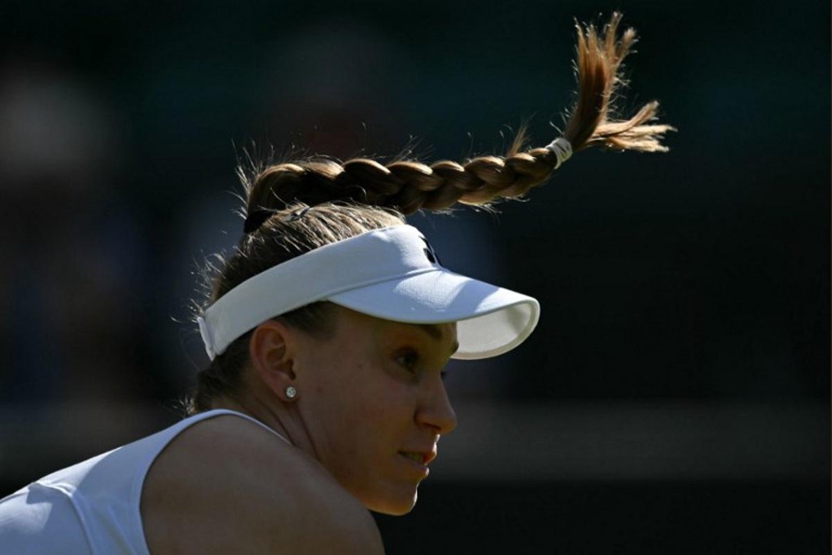 Kazakhstan's Elena Rybakina returns to France's Lois Boisson during their women's singles first round tennis match on the second day of the 2026 Wimbledon Championships at The All England Lawn Tennis and Croquet Club in Wimbledon, southwest London, on June 30, 2026.  Glyn KIRK / AFP