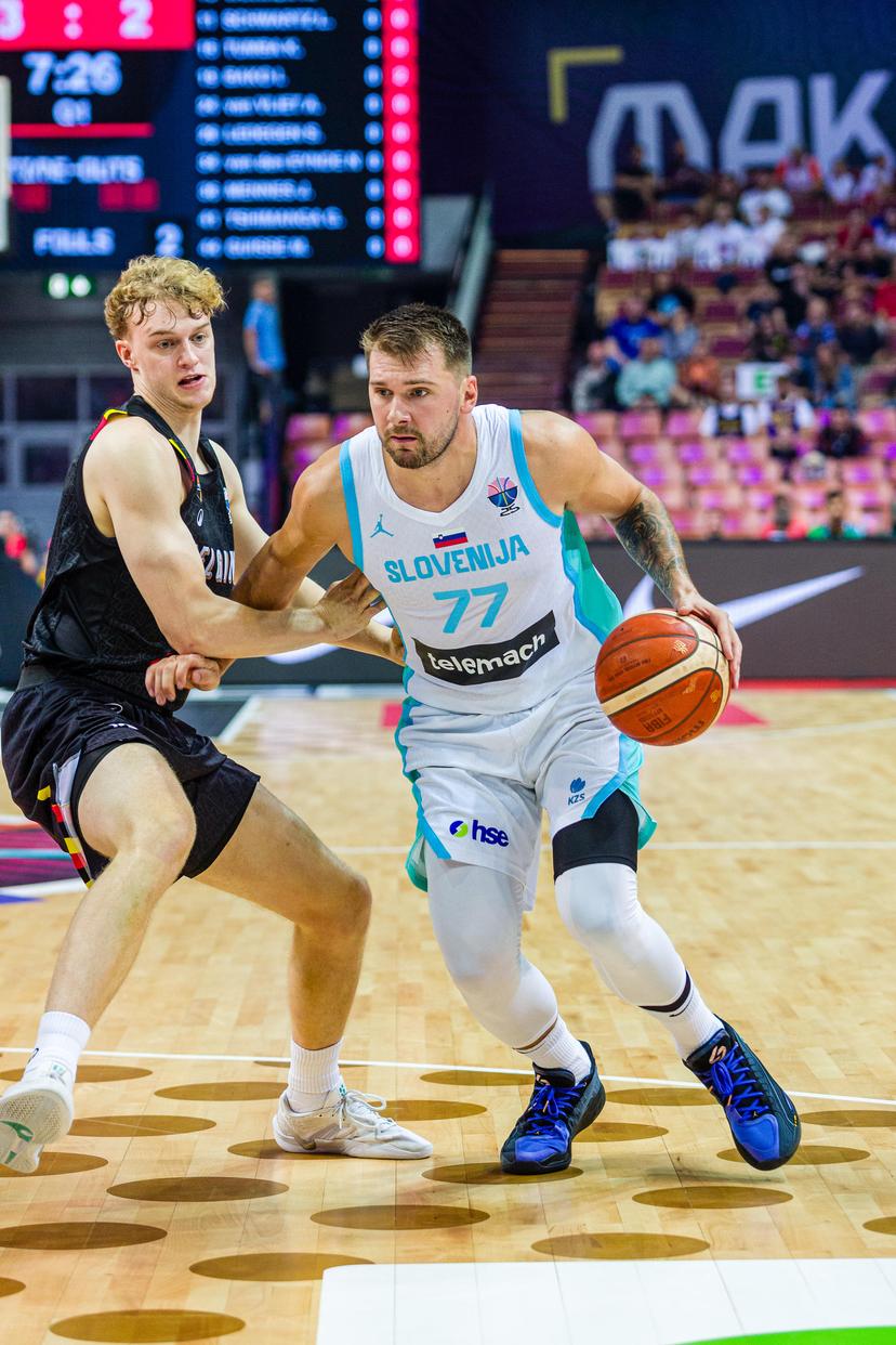 Belgium's Joppe Mennes and Slovenian Luka Doncic pictured in action during a basketball match between Belgium's national team Belgian Lions and Slovenia, Sunday 31 August 2025 in Katowice, Poland, the third game of the group stage of the Eurobasket 2025 European championships. BELGA PHOTO PAWEL PIETRANIK *** BELGIUM ONLY ***