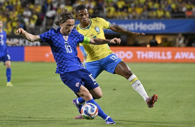 Croatia's midfielder #10 Luka Modric and Brazil's midfielder #18 Danilo De Oliveira vie for the ball during a friendly football match between Brazil and Croatia at Camping World Stadium in Orlando, Florida, on March 31, 2026.  MIGUEL J RODRIGUEZ CARRILLO / AFP