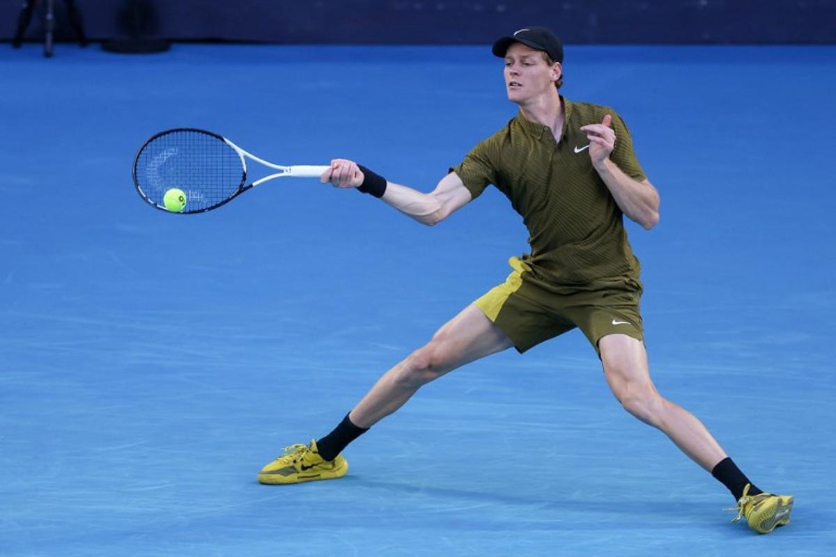 Italy's Jannik Sinner hits a return to Australia's James Duckworth during their men's singles match on day five of the Australian Open tennis tournament in Melbourne on January 22, 2026.  IZHAR KHAN / AFP