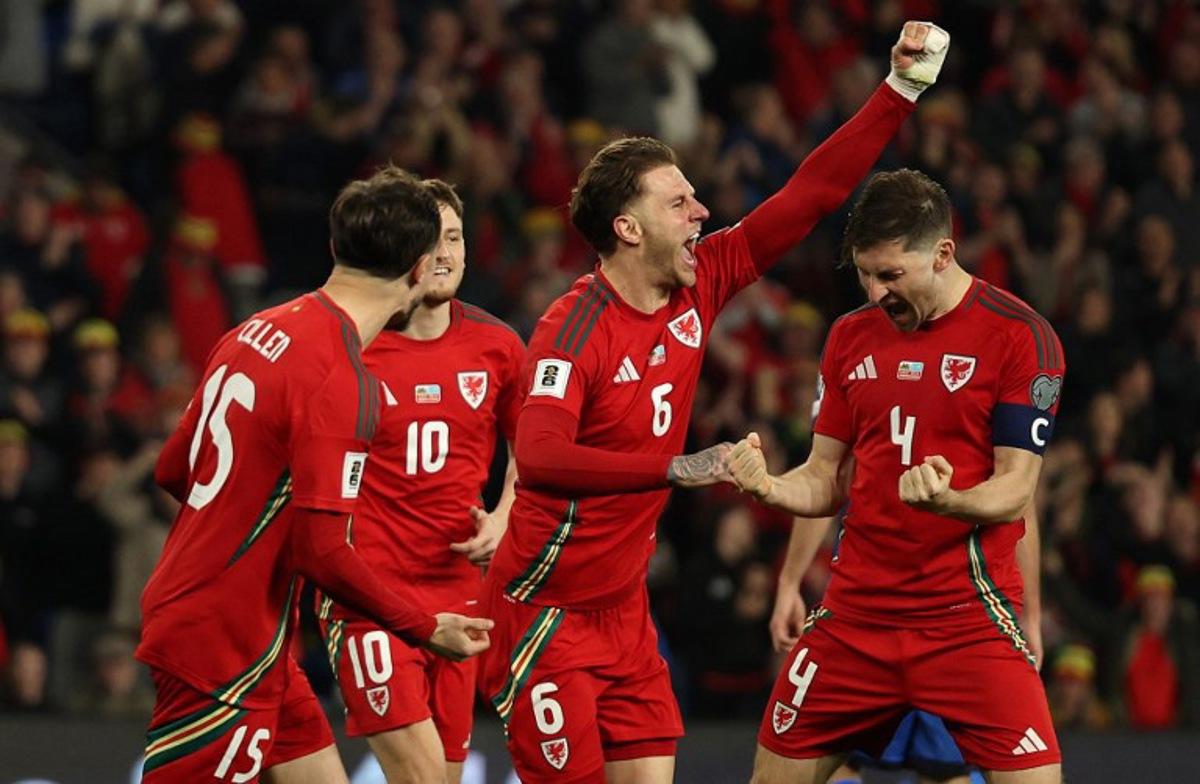 Wales' defender #04 Ben Davies (R) celebrates scoring the team's second goal during the 2026 World Cup Group J qualifier football match between Wales and Kazakhstan, at Cardiff City Stadium, in Cardiff, on March 22, 2025.   Adrian Dennis / AFP