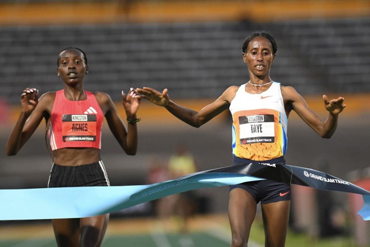 Ethiopia's Ejgayehu Taye (R) of team Nike crosses the finish line in first place ahead of    Kenya's Agnes Jebet Ngetich of team Adidas in the the women's 3000 meters Long Distance during the Grand Slam Track competition at the National Stadium in Kingston, Jamaica on April 4, 2025.  Ricardo Makyn / AFP