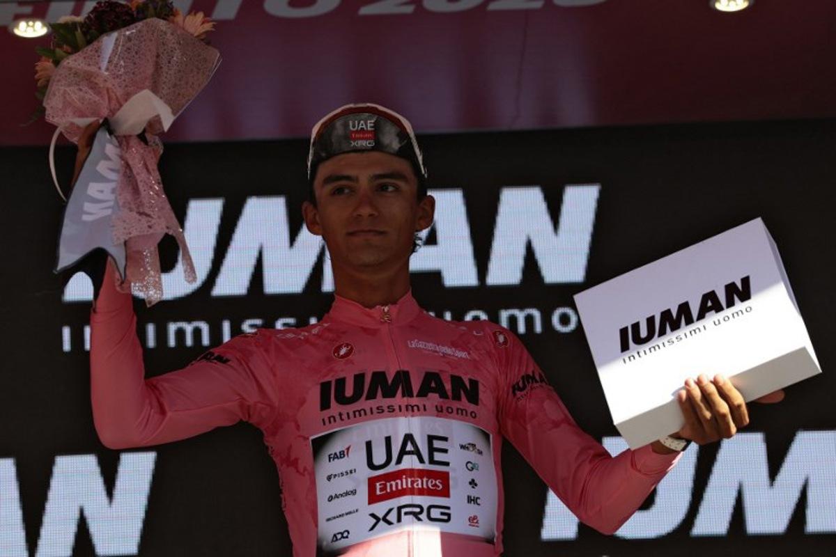 UAE Team Emirates XRG's Mexican rider Isaac Del Toro celebrates with the pink jersey of overall leader on the podium of the 9th stage of the 108th Giro d'Italia cycling race of 181kms from Gubbio to Siena on May 18, 2025.  Luca Bettini / AFP