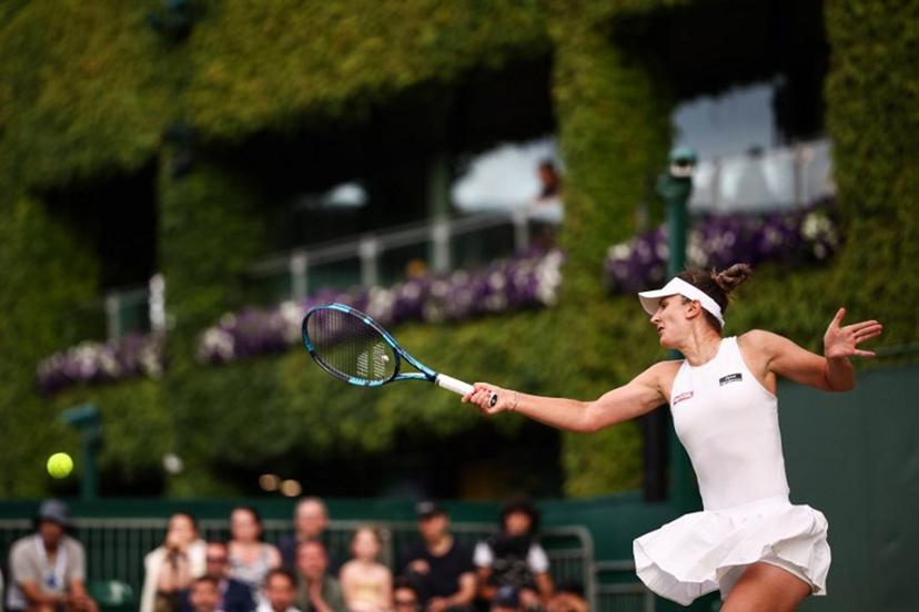 Romania's Irina-Camelia Begu returns the ball to Australia's Daria Kasatkina during their women's singles second round tennis match on the fourth day of the 2025 Wimbledon Championships at The All England Lawn Tennis and Croquet Club in Wimbledon, southwest London, on July 3, 2025.  HENRY NICHOLLS / AFP