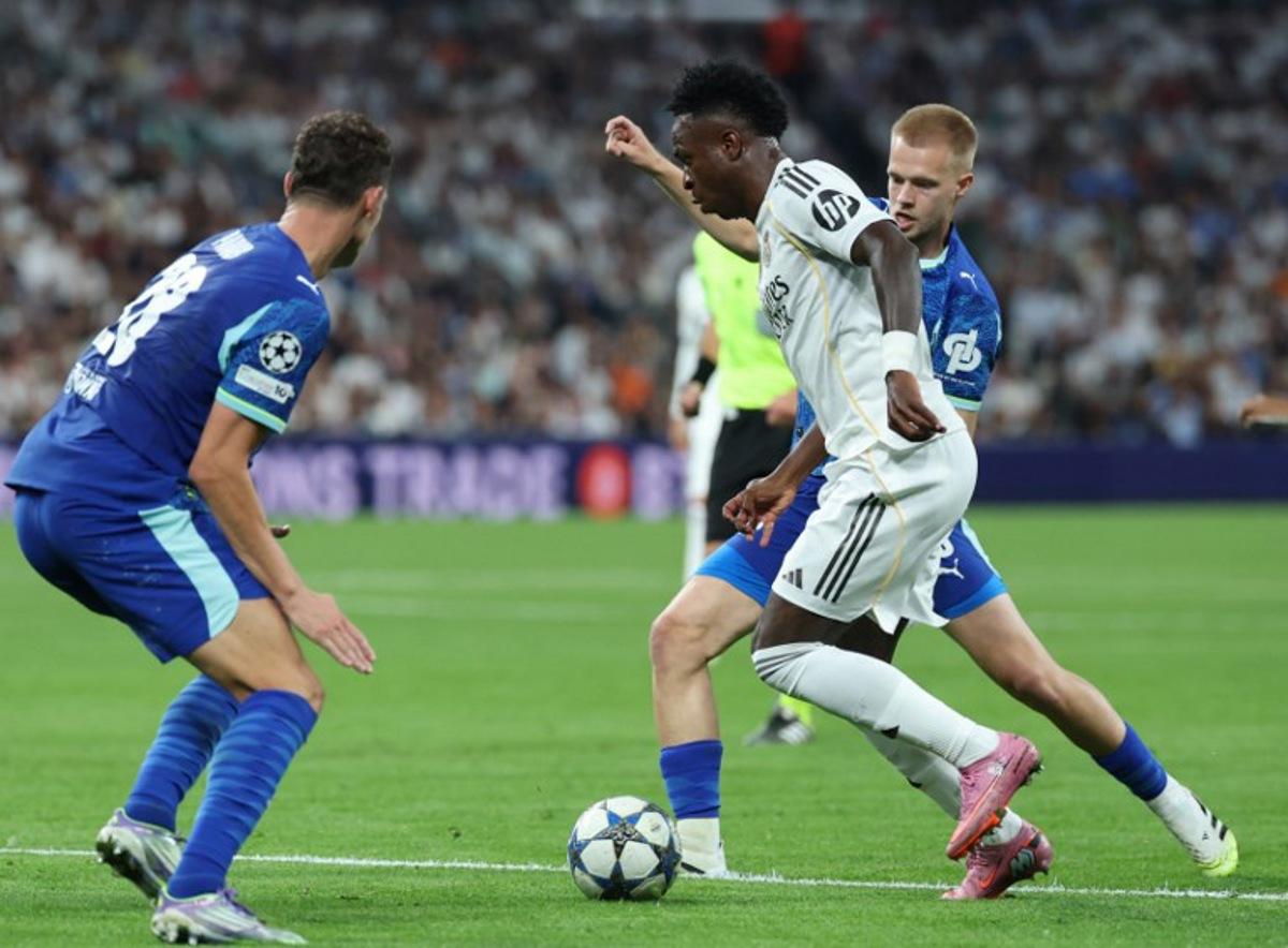 Real Madrid's Brazilian forward #07 Vinicius Junior fights for the ball with Marseille's Belgian midfielder #18 Arthur Vermeeren during the UEFA Champions League first round day 1 football match between Real Madrid CF and Olympique de Marseille at the Santiago Bernabeu stadium in Madrid on September 16, 2025.  Thomas COEX / AFP
