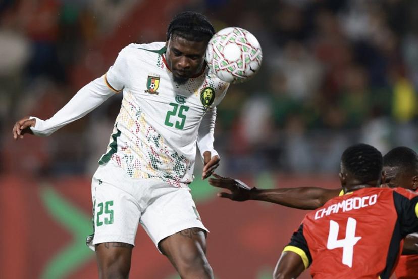 Cameroon's midfielder #25 Junior Dina Ebimbeheads the ball during the Africa Cup of Nations (CAN) Group F football match between Mozambique and Cameroon at the Grand Stadium in Agadir on December 31, 2025.   FRANCK FIFE / AFP