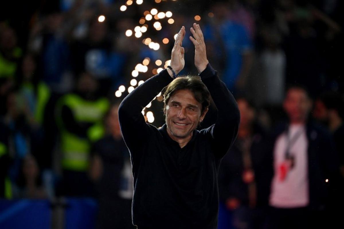 Napoli's Italian coach Antonio Conte applauds ahead of the trophy ceremony for the Italian Champions following the Italian Serie A football match between Napoli and Cagliari at the Diego Armando Maradona stadium in Naples on May 23, 2025.  Isabella BONOTTO / AFP