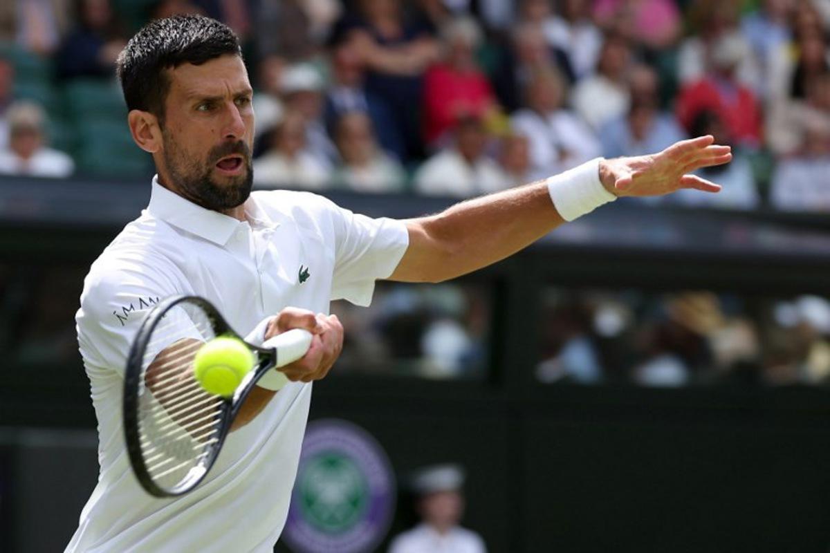 Serbia's Novak Djokovic plays a forehand return to Australia's Alex De Minaur during their men's singles fourth round tennis match on the eighth day of the 2025 Wimbledon Championships at The All England Lawn Tennis and Croquet Club in Wimbledon, southwest London, on July 7, 2025.  Adrian Dennis / AFP