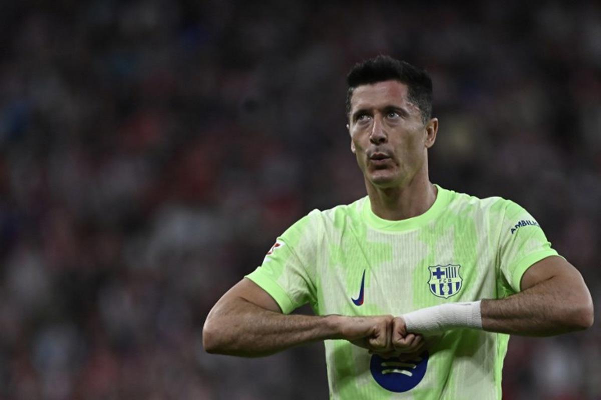 Barcelona's Polish forward #09 Robert Lewandowski celebrates scoring his second goal during the Spanish league football match between Athletic Club Bilbao and FC Barcelona at San Mames Stadium in Bilbao, on May 25, 2025.  ANDER GILLENEA / AFP