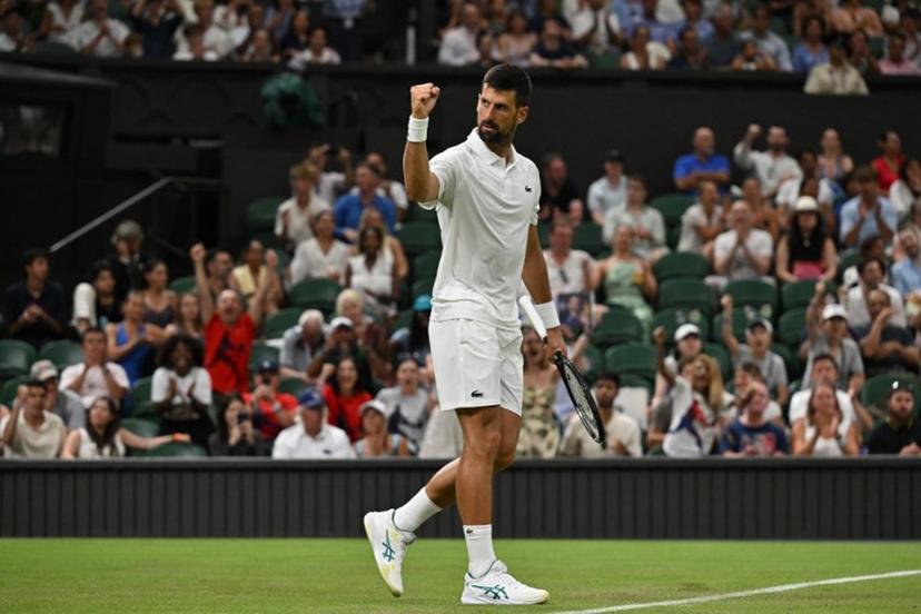 Serbia's Novak Djokovic reacts after a point as he plays against France's Alexandre Muller during their men's singles first round tennis match on the second day of the 2025 Wimbledon Championships at The All England Lawn Tennis and Croquet Club in Wimbledon, southwest London, on July 1, 2025.  Glyn KIRK / AFP