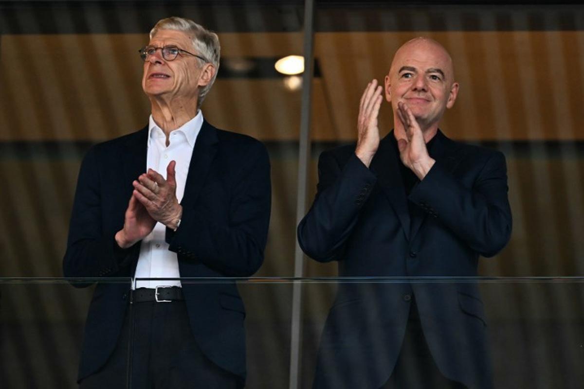 Former Arsenal's French manager Arsene Wenger (L) and FIFA President Gianni Infantino  applaud ahead of the UEFA Women's Euro 2025 quarter-final football match between Sweden and England at Letzigrund Stadium in Zurich, on July 17, 2025.  Fabrice COFFRINI / AFP