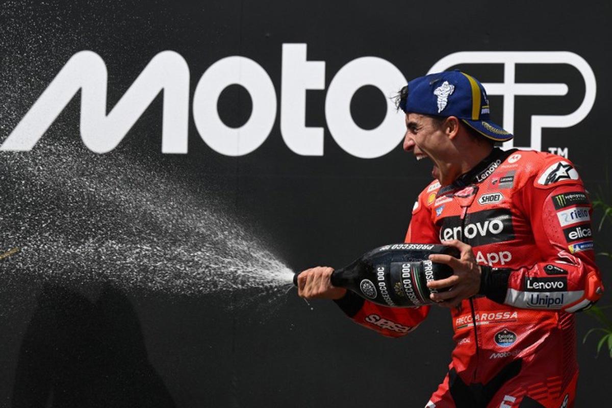 First placed Ducati Lenovo Team's Spanish MotoGP rider Marc Marquez celebrates on the podium after winning the motorcycle Czech Moto GP at the Masaryk circuit in Brno, Czech Republic on July 20, 2025.   Michal Cizek / AFP